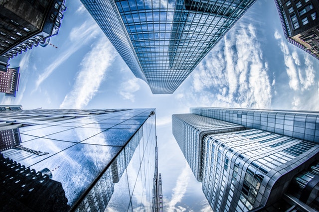 Glass skyscrapers photographed looking straight up between the buildings
